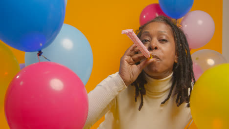 Studio-Portrait-Of-Woman-Wearing-Birthday-Headband-Celebrating-With-Balloons-And-Party-Blower-1